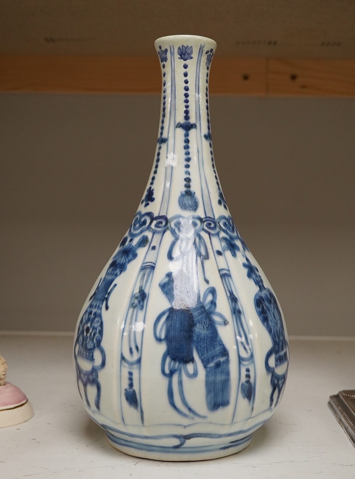 An early 17th century Chinese kraak blue and white bottle vase, 28.5cm. Condition - restored